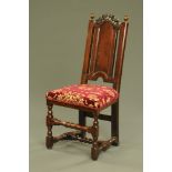 A 17th century oak dining chair with pierced and scrolled cresting and plain splat,