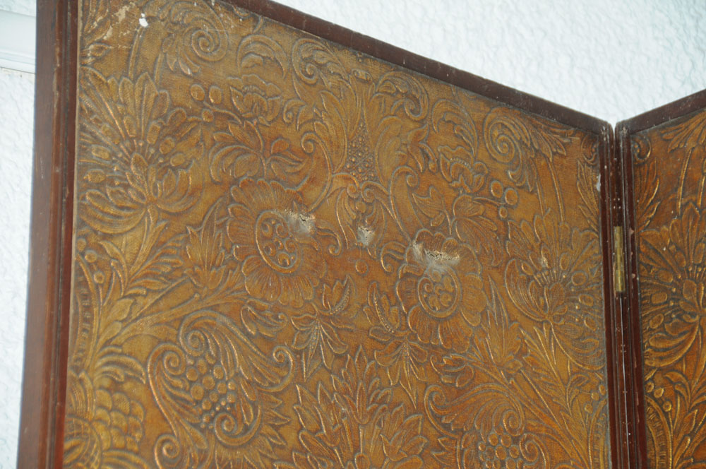 A massive mahogany four fold screen, with gilt embossed cloth panels. - Image 2 of 10