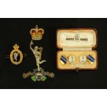 A pair of Royal Signals enamelled and gold plated cufflinks, a cap badge and cloth badge.