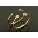 Two 9 ct gold bangles, one with heart shaped terminals set with paste stones, 25.2 grams gross.