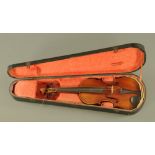 A German violin, bearing label Maggini 1886. Length of back 35.5 cm, cased.