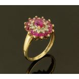 A 9 ct gold ruby and diamond cluster ring, Size K.