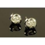 A pair of 18 ct white gold diamond stud twist set earrings, with diamonds weighing +/- .50 carats.