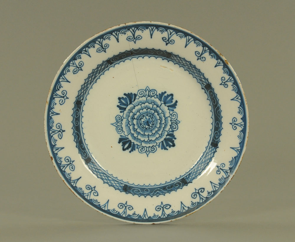 An 18th century Delft Faience charger, decorated in blue with floral motifs.