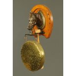 A Victorian oak and bronzed spelter racehorse dinner gong, with horseshoe patterned back,