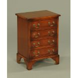 A small reproduction mahogany chest of four long graduated drawers,