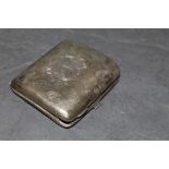 An early 20th century silver cigarette case with engraved initials SH,