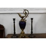 A pair of oak candlesticks, 33 cm high and a decorative ewer with gilt metal base and spout,