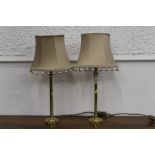 Pair of brass effect table lamps with shades,