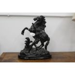 A cast figural ornament of a man on a horse,