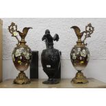 Pair of gilt metal ewers with floral design and a single ewer with bacchus face design to front ,