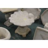 A shell shaped bird bath