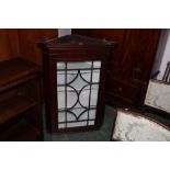 Mahogany hanging corner cupboard with 20 panel glazed door, height 106 cm,