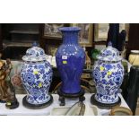 Pair of blue and white lidded vases and tall blue vase