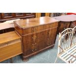 A walnut chest of drawers with four long drawers with brass swans neck handles.