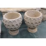 A pair of concrete garden planters,