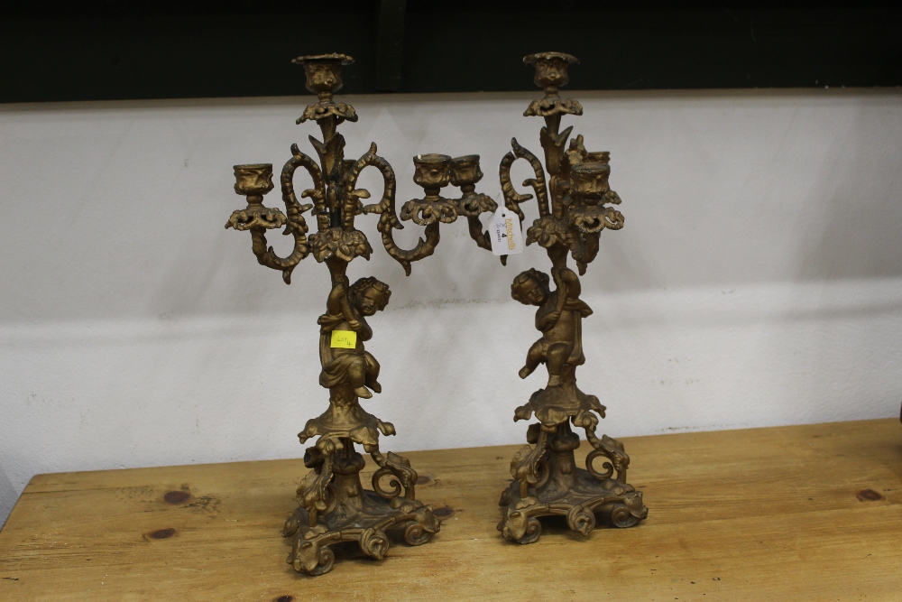 Two gilt metal three branch candelabras