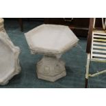 A bird bath with hexagonal top,