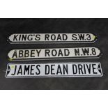 Three road sighs (two wood and one metal) Abbey Road, Kings Road, and James Dean Drive.