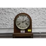 Small early 20th century mantel clock with silvered dial, 18 cm wide, 21 cm high.