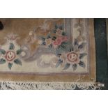 An oriental peach and floral patterned rug, 185 x 120 cm,