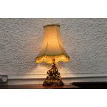 Giltwood effect table lamp and shade with cherub base, height +/-64 cm.