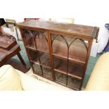 A mid 19th century bookcase top with arched nine panel glazed doors