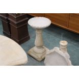 A bird bath with circular top,