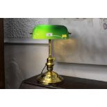 Brass effect desk lamp with green glass shade.