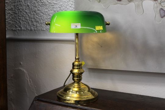 Brass effect desk lamp with green glass shade.