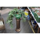 Green glazed planter and artificial plant on gilt coloured column