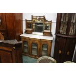 Edwardian walnut mirror back sideboard, of small proportion, with marbled top and glazed doors,