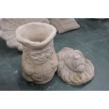 A concrete garden planter in the form of a Toby jug and a lion mask