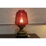Victorian Veritas oil lamp converted to electric with large cranberry glass shade with brass