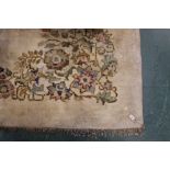 A large cream and floral patterned rug,