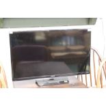 Samsung flat screen TV set with remote control, 32" screen.