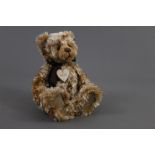 A soft plush Charlie Bear, named 'Hobnob', wearing a heart shaped name tag around its neck,