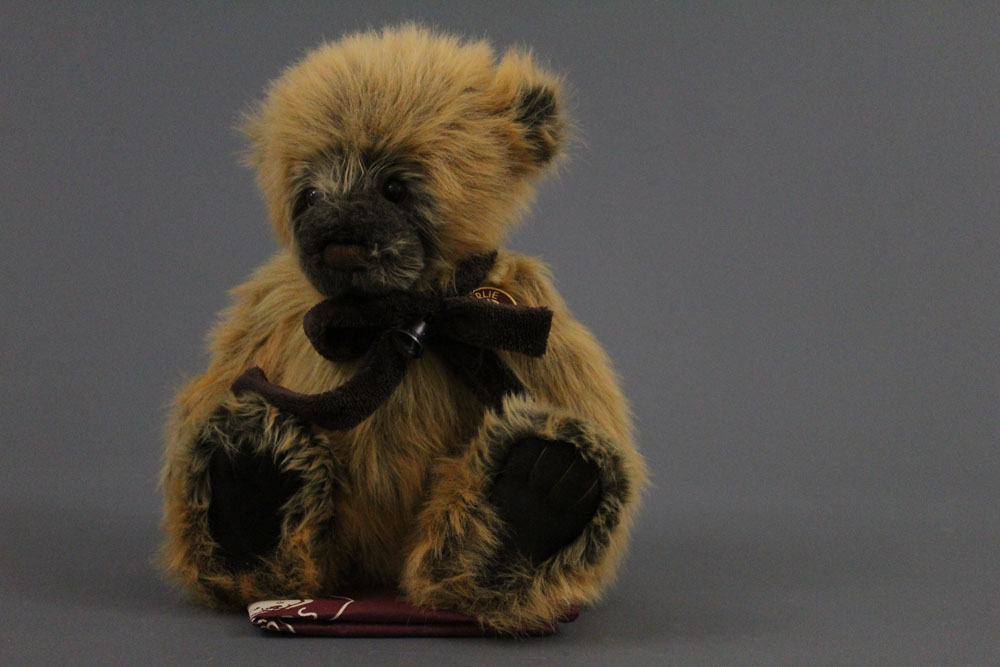 A soft plush Charlie Bear, named "Bobby Dazzler" having dark with golden tip fur covered body,