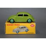 A Dinky Volkswagen Beetle (181), having a lime green body and mid green hubs,