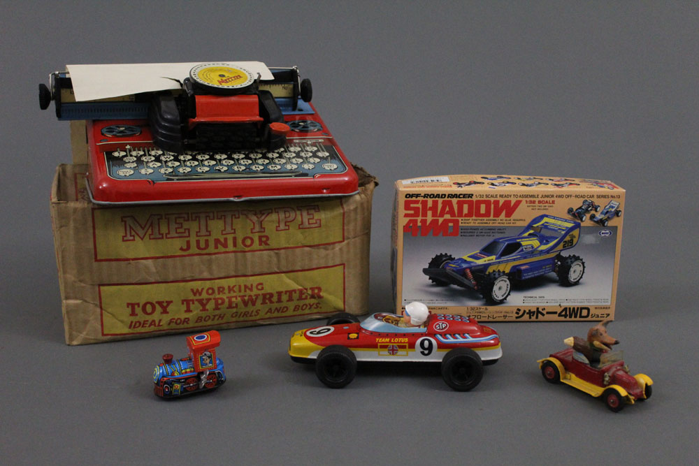 A boxed Mettoy Mettype Junior Typewriter, two modern tinplate toys,