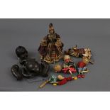 A group of dolls, parts, and puppets of varying ages and designs,