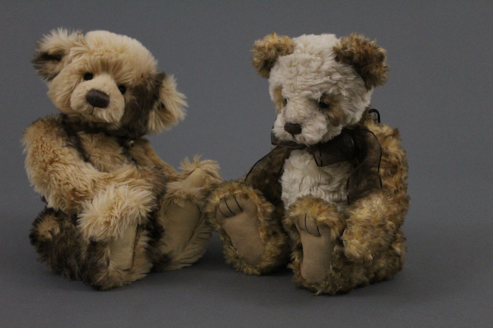 Two soft plush Charlie Bears, one with satin brown bow around its neck, the tallest measuring 36 cm.