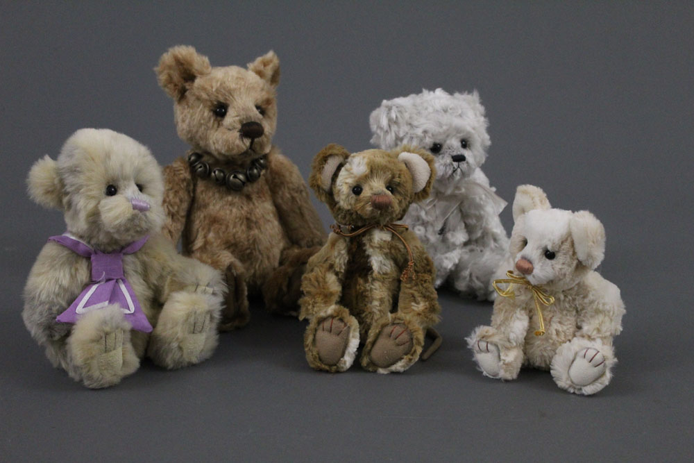 Five soft plush Charlie Bears, of varying sizes,