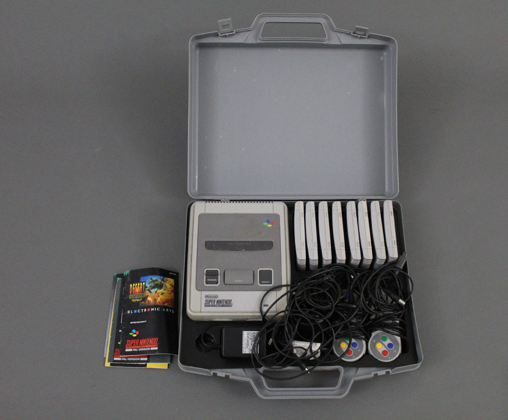 A cased Nintendo Super Nintendo Entertainment System, and sold together with eight games,