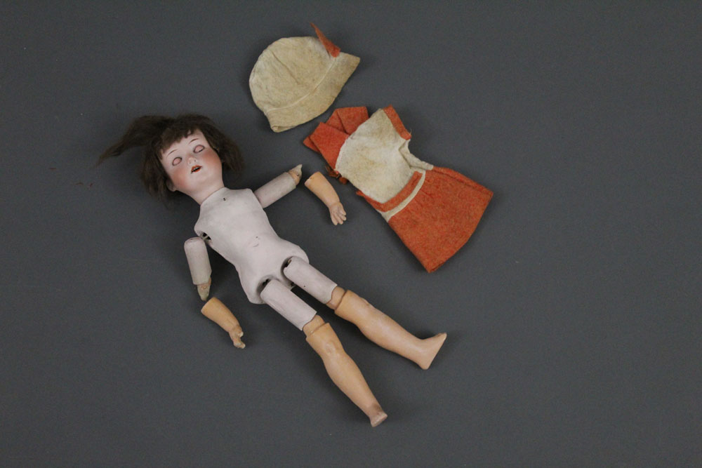 An Armand Marseille 390n bisque head doll, with blue sleep eyes, open mouth and four teeth,