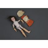 An Armand Marseille 390n bisque head doll, with blue sleep eyes, open mouth and four teeth,