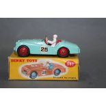 A Dinky Triumph TR2 sports car (111), having a turquoise body, red interior and hubs,