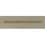 A 1920's knotted wood and Chinese embossed white metal handled walking cane. 93 cm long.