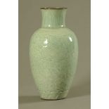 A Chinese celadon porcelain bulbous vase, carved in relief with leafage and with cafe au lait rim.