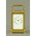 An Edwardian brass carriage clock, with repeat mechanism, timepiece and striking. Height 12.5 cm.